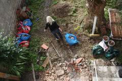 Tina and I staking rubble against wall in garden