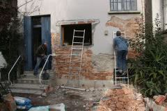 John and David start work on outside wall, knocking off all old loose render