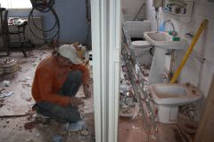 John working after wall in bathroom taken down