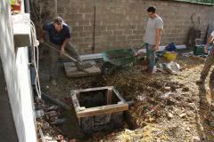 John builds new drains in garden