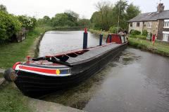 Work boat awaiting bridge to open Leeds Liverpool canal