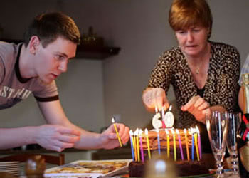 Fitting candles on John's birthday cake
